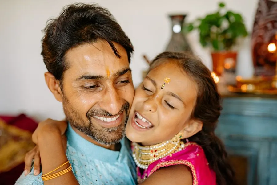 A father and his daughter hugging and laughing during a celebration