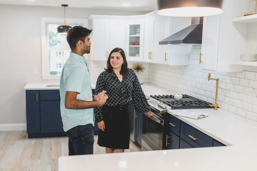 A couple looking around the kitchen of an apartment during a visit